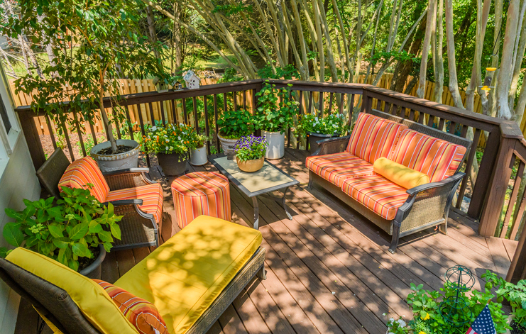 Brightly upholstered patio furniture on wooden deck