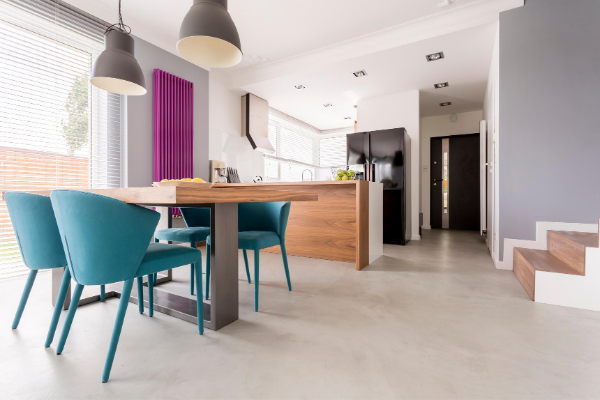 Kitchen and dining room area with teal chairs and magenta wall art